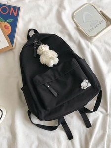 Minimalist black canvas school backpack with cute bear pendant and rabbit patch detail