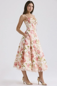 Detail of floral spaghetti strap dress showing delicate lace hem and pink flower patterns
