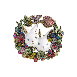 Vintage gold rabbit brooch with colorful rhinestones and white enamel wreath design
