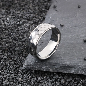 Industrial style hammered texture stainless steel ring for men on dark rock background
