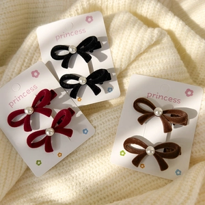 Three pairs of elegant velvet bow hair clips with pearls in red, black, and brown