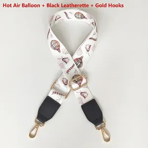 Detail of adjustable bag strap with colorful hot air balloon print and gold metal hook