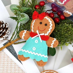 Gingerbread man felt ornament with green dress and red bow for Christmas tree decoration