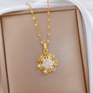Elegant gold titanium necklace featuring a spinning hollow snowflake pendant with crystals