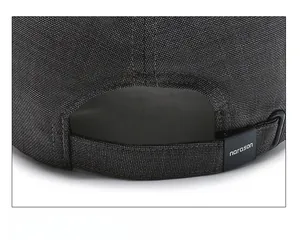 Detail of adjustable Velcro strap and buckle on the back of the grey baseball cap