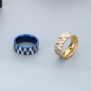 Close-up of wavy stainless steel rings featuring two-tone metallic droplet textures
