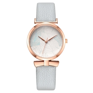 Women's watch with rose gold bow detail, white dial, and light grey leather strap