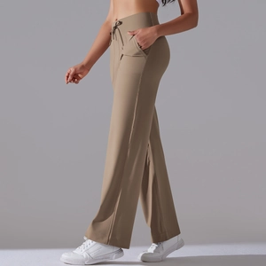 Detail of high waisted wide leg yoga pants with drawstring waist and side pockets