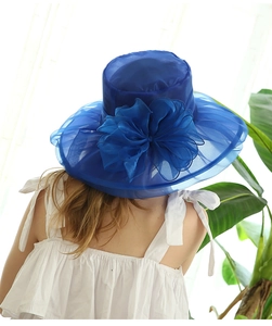 Rear view of a blue wide-brim mesh sun hat featuring a large 3D organza flower detail