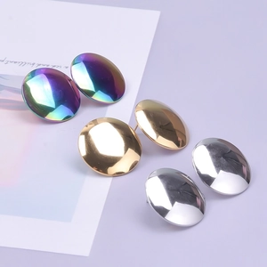 Close-up of three pairs of round 304 stainless steel stud earrings in rainbow, gold, and silver