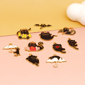 Detailed flat lay of ten varied black cat Halloween alloy charms on colorful background
