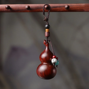 Handcrafted rosewood gourd keychain with woven cord and decorative beads in traditional style