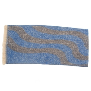 Detail of blue and grey wavy knit scarf showing fringe edge and soft wool texture