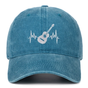 Close-up of white guitar heartbeat embroidery on washed cotton baseball cap