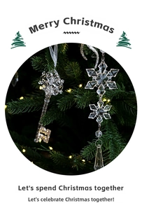 Close-up of clear crystal Christmas tree ornaments in snowflake and key shapes
