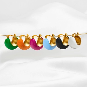 Colorful C-shaped enamel hoop earrings in gold plating on elegant white silk background