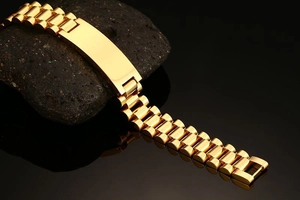 Detailed view of a gold-plated stainless steel watchband bracelet with engravable bar plate