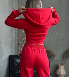 Vista posteriore della tuta rossa da donna con strisce laterali azzurre sui pantaloni