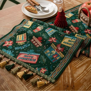 Green Christmas table runner with tassels featuring festive jacquard gift patterns