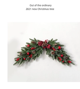 Detail of Christmas swag with pine needles, red berries, cones, and a plaid bow decoration