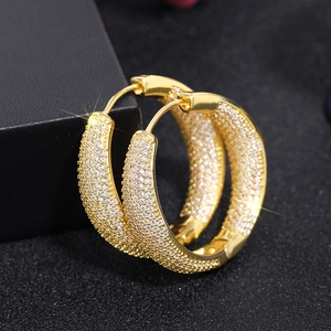 Elegant gold-plated hoop earrings with micro-pave crystals on dark background