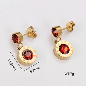 Golden earrings with red crystal centers and engraved Roman numerals on circular pendants