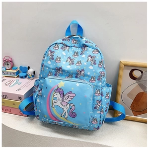 Detail of light blue kids backpack with unicorn and rainbow prints in a cozy setting