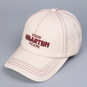 Detailed macro view of the contrast stitching and red embroidered lettering on the cap