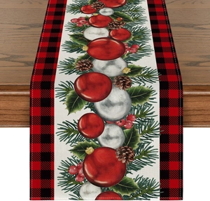 Detailed macro view of Christmas table runner with festive pine cones and buffalo plaid edges