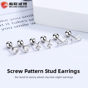 Detailed macro of S925 sterling silver screw back earrings with heart and bow motifs