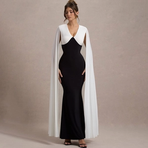Detail of elegant black and white V-neck evening gown with long cape-style sleeves