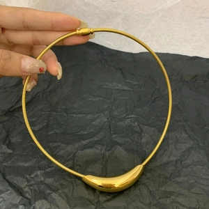 Modern gold curved titanium steel necklace with a polished bar pendant for women