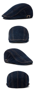 Detail view of denim beret with orange contrast stitching and side metal buckle