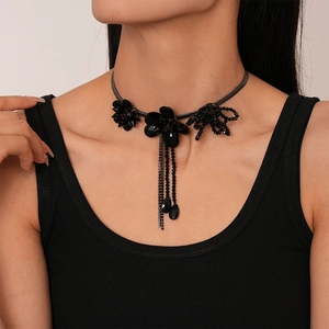 Detailed macro view of black floral tassel choker featuring crystal drop charms