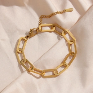 Minimalist 18K gold stainless steel paperclip chain bracelet on pink silk background