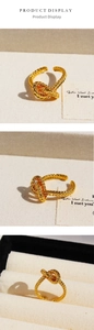 Detailed views of gold plated twisted knot open ring with woven rope texture design