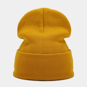 Detailed view of the ginger yellow knitted beanie showing vertical ribbed texture and fabric