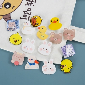 Cute cartoon acrylic animal brooches featuring ducks and bears on white canvas bag