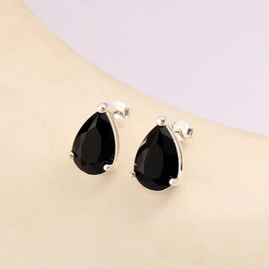 Detailed view of S925 hallmark on silver earrings with black teardrop zircon