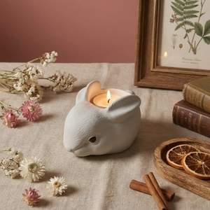 Matte white ceramic rabbit candle holder for tealight in a cozy home decor setting