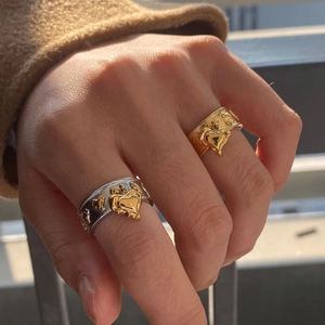 Asymmetric 18k gold plated stainless steel criss-cross rings with heart charms