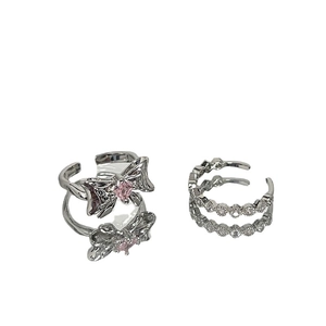 Silver bow ring with pink zircon and double layered crystal band on white background