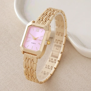 Elegant gold square watch with pink dial and metal chain strap on ceramic display