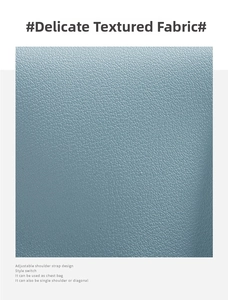 Macro detail of blue-grey pebble leather texture and adjustable bag strap design