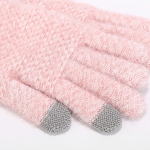 Close-up of pink knit gloves with grey touchscreen tips and soft thermal fiber texture
