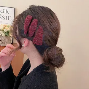 Set of three vintage plush red-brown triangle hair clips on model's bun hair styling