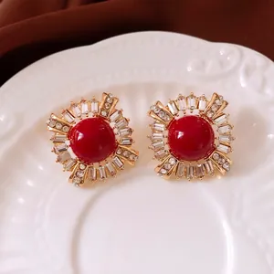Vintage style round earrings with large red stone and sparkling crystals in gold setting