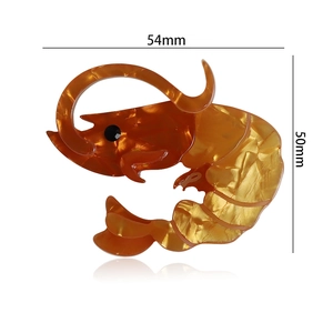 Detail shot of amber acrylic lobster brooch with size markers 54mm by 50mm on white