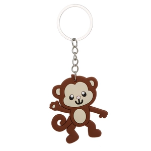 Detail of a brown monkey animal keychain made of soft PVC with silver metal ring