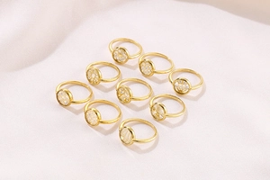 Macro shot of 9 gold geometric hollow rings with zircon inlay and grid patterns